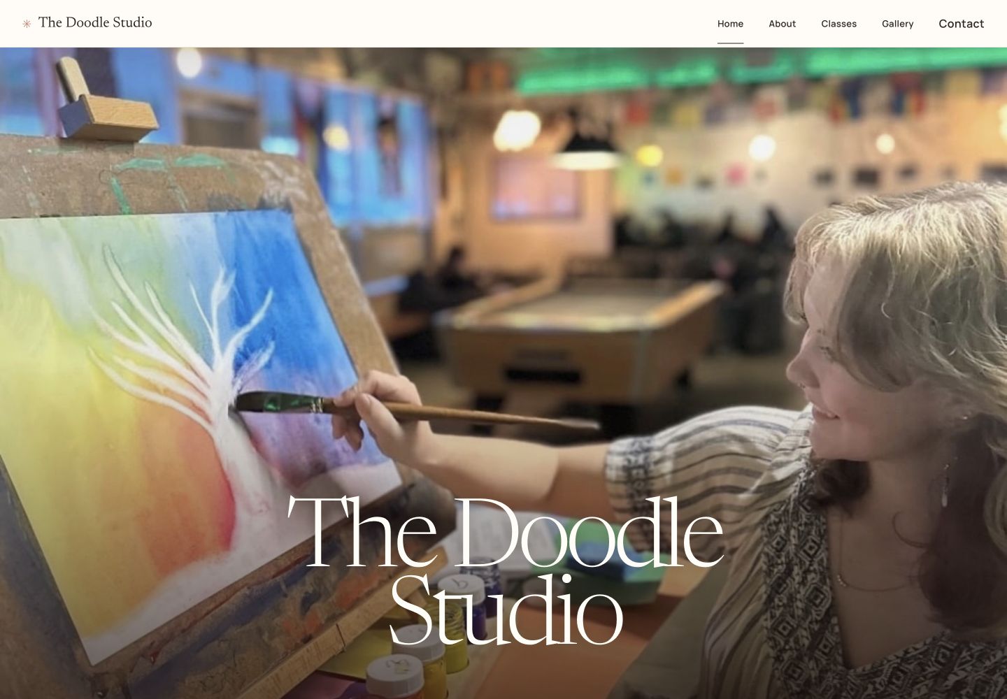 The Doodle Studio homepage: a large art-making photograph, expressive serif title, and navigation to About, Classes, Gallery, and Contact.
